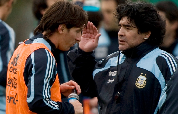 Argentina's national soccer team coach Maradona gives instructions to Messi during a training session at the squad's camp in Buenos Aires